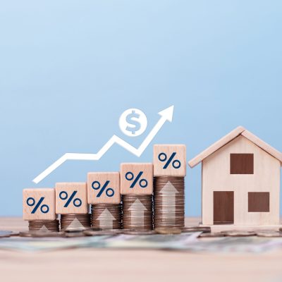 Real estate business, Interest Rate and home insurance concept. Chart growth rate and growing arrow with home model. investment returns, fund, Buy and sell houses. loans. Mortgage. Property tax.