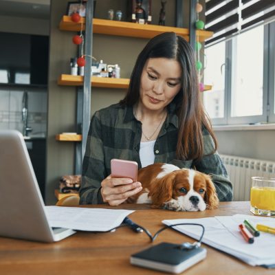woman working from home in the company of her dog
